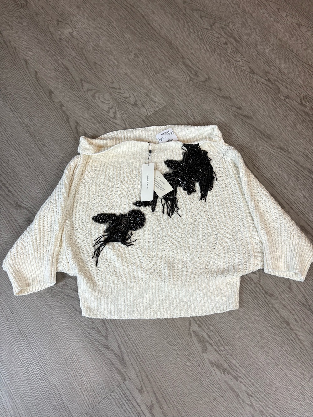 Hellessy Nolan
Off-the-Shoulder Cream Sweater with Black Bead Floral Appliqué